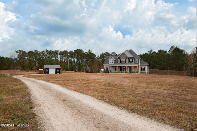 view of front facade with an outdoor structure, a porch, and a garage