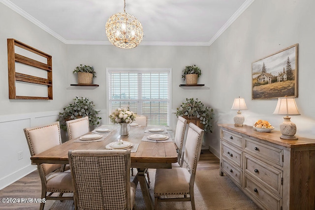 dining room featuring dark hardwood / wood-style flooring, a chandelier, and ornamental molding