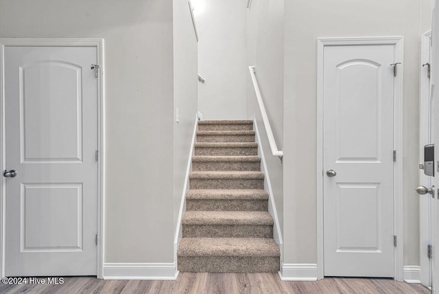 staircase featuring hardwood / wood-style flooring