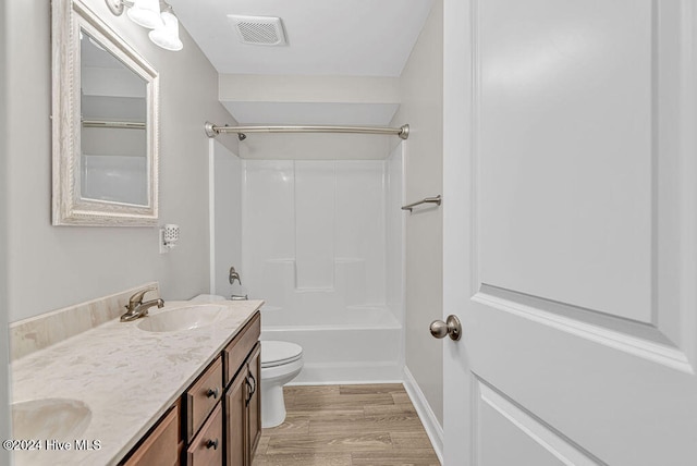 full bathroom with toilet, vanity, tub / shower combination, and hardwood / wood-style flooring