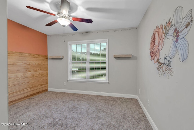 unfurnished room featuring light colored carpet and ceiling fan