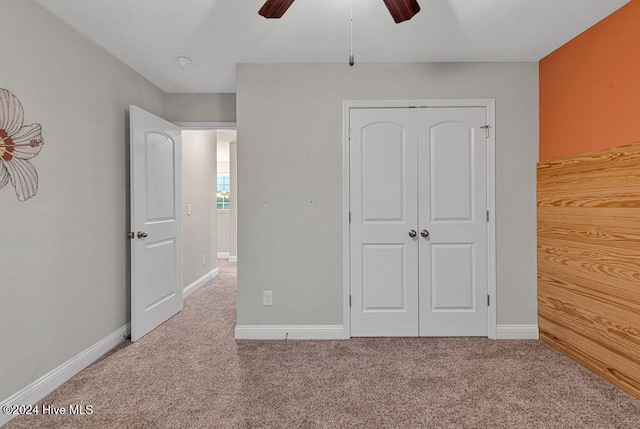 unfurnished bedroom featuring carpet floors and ceiling fan