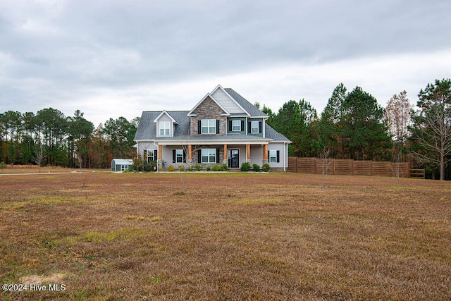 view of front of home with a porch and a front lawn