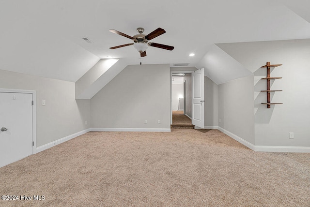 additional living space featuring ceiling fan, light colored carpet, and lofted ceiling