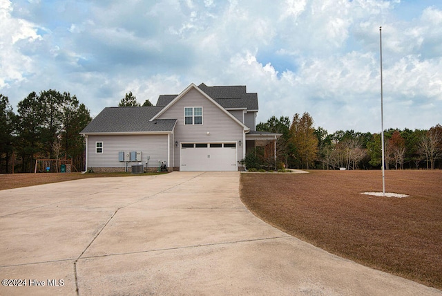 view of front facade featuring central AC unit and a garage