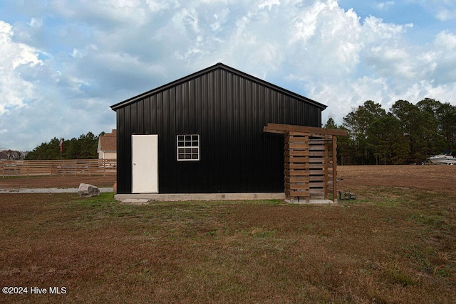 view of outbuilding with a yard