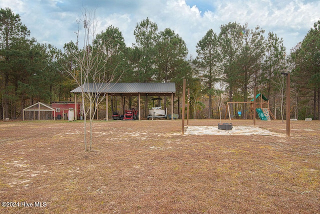 view of yard with a playground and a carport