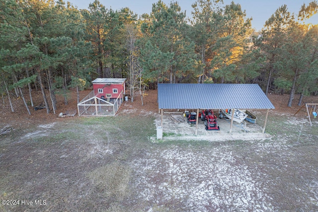 view of yard featuring an outdoor structure and a carport