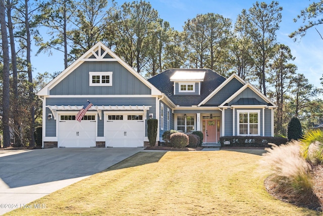 craftsman-style house with a garage and a front lawn