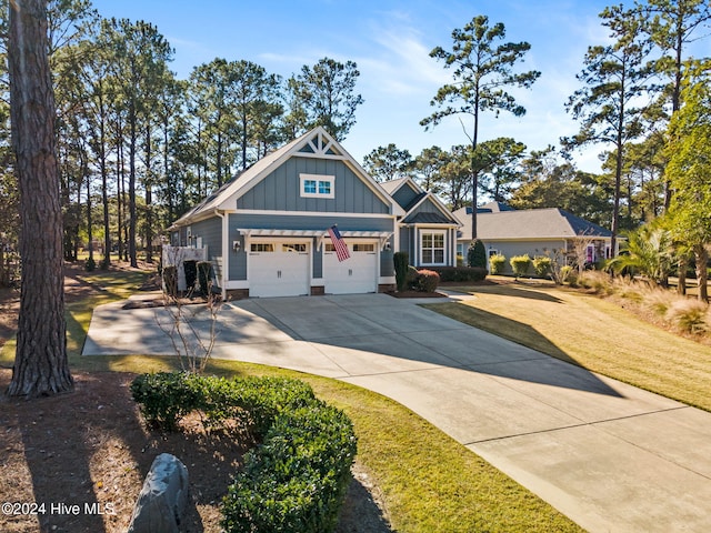 craftsman inspired home featuring a garage and a front lawn