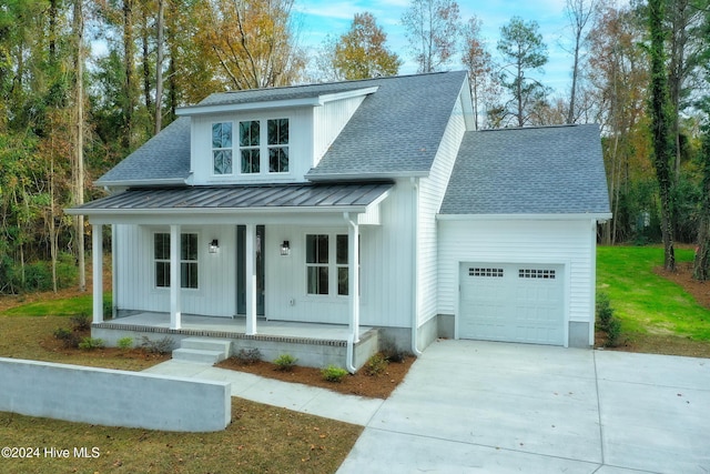 view of front facade with a porch, a garage, and a front lawn