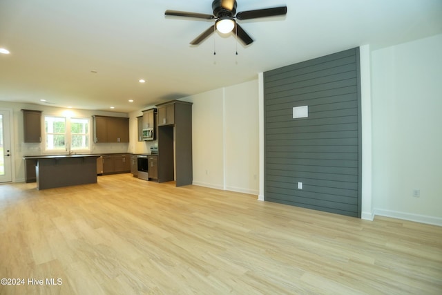 unfurnished living room featuring light wood-type flooring and ceiling fan