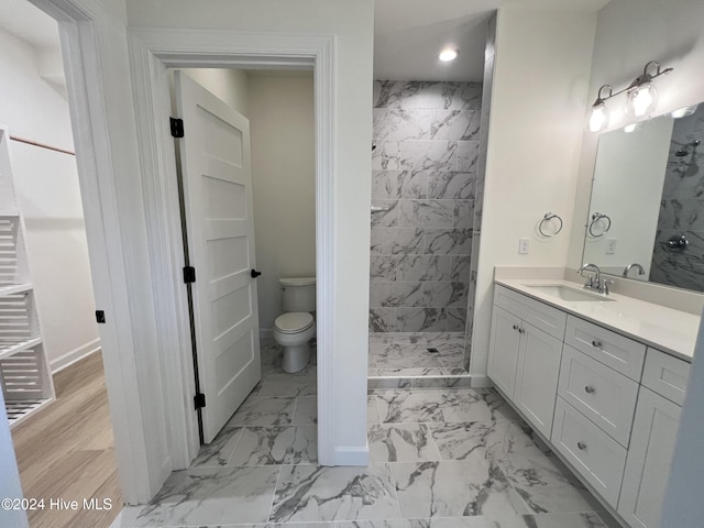 bathroom with toilet, walk in shower, and vanity