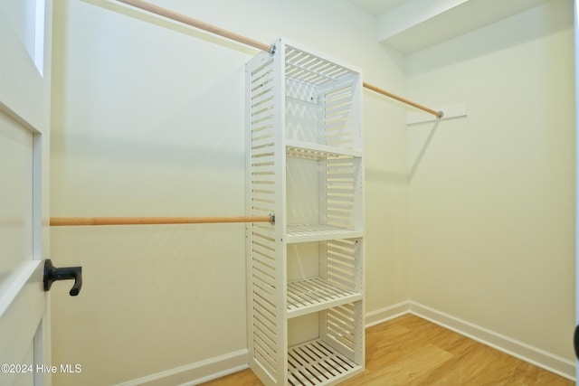 spacious closet with light hardwood / wood-style flooring