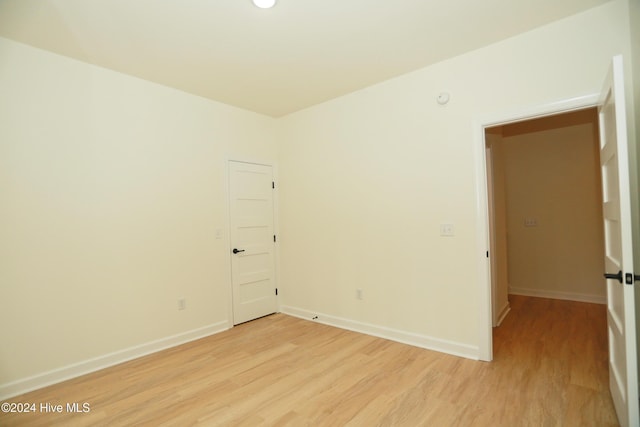 unfurnished room with light wood-type flooring