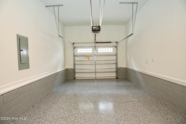 garage with electric panel and a garage door opener