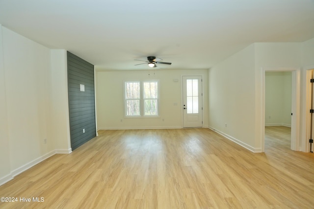 unfurnished living room featuring ceiling fan and light hardwood / wood-style flooring