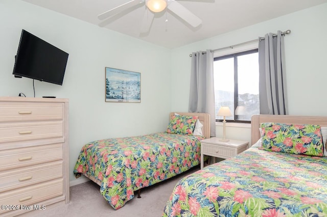 bedroom with ceiling fan and light carpet