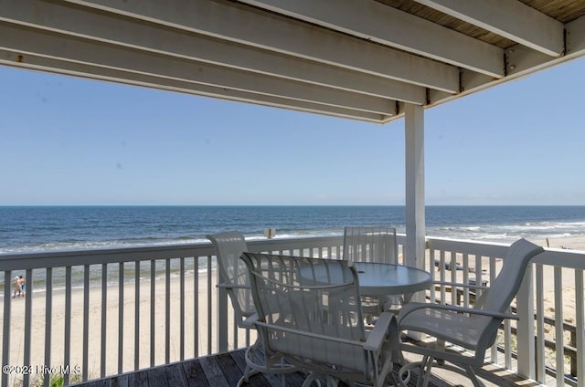 deck featuring a water view and a view of the beach