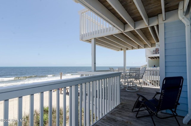 deck with a water view and a beach view