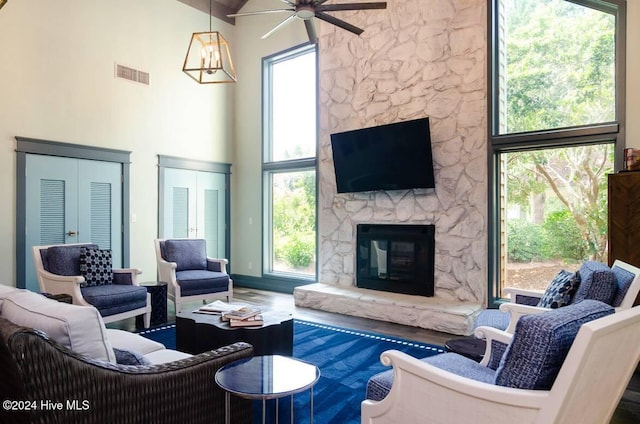 living room with a healthy amount of sunlight and a high ceiling