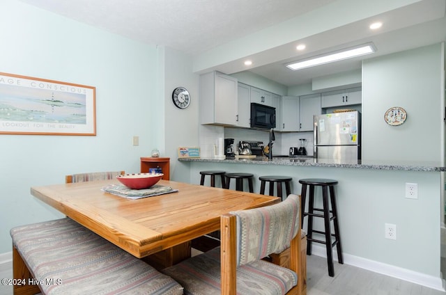 dining space featuring light hardwood / wood-style flooring