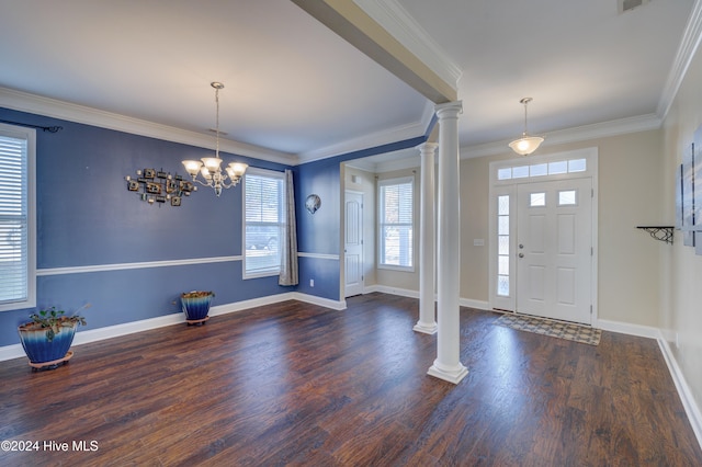 entrance foyer with dark hardwood / wood-style flooring, decorative columns, and ornamental molding