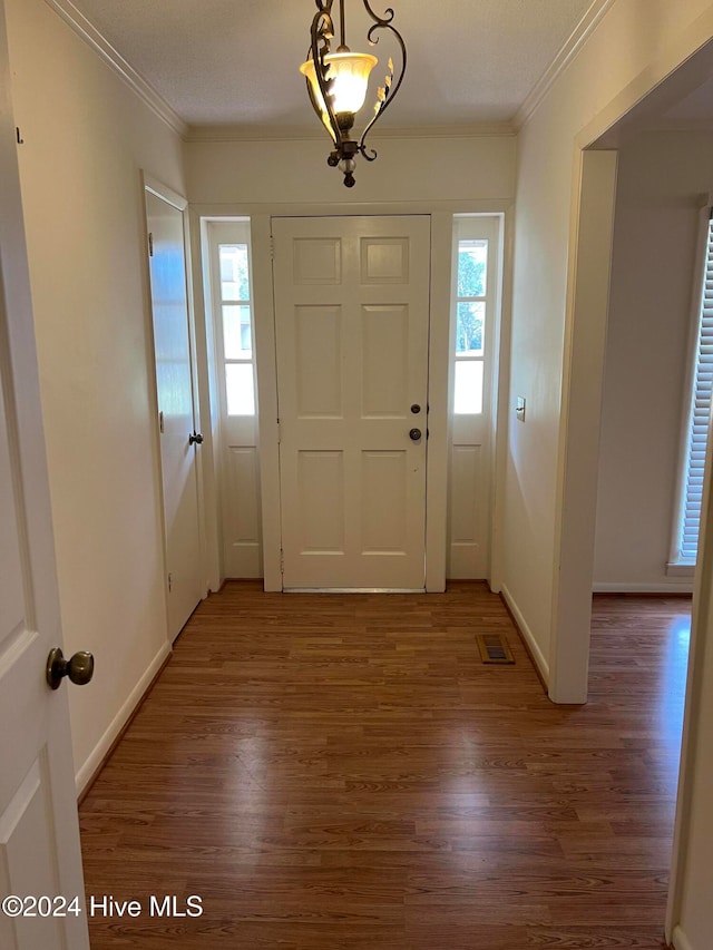 entryway featuring dark hardwood / wood-style floors and ornamental molding