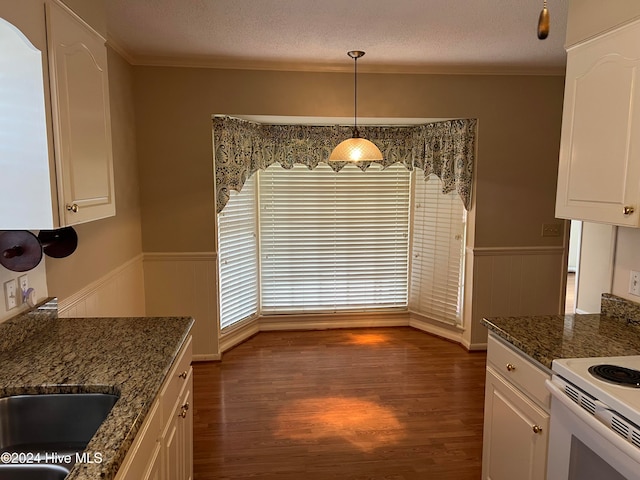 kitchen with white cabinets, hanging light fixtures, dark wood-type flooring, and dark stone countertops