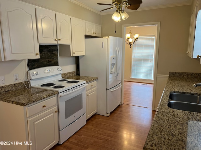 kitchen with ceiling fan with notable chandelier, white appliances, white cabinetry, and sink