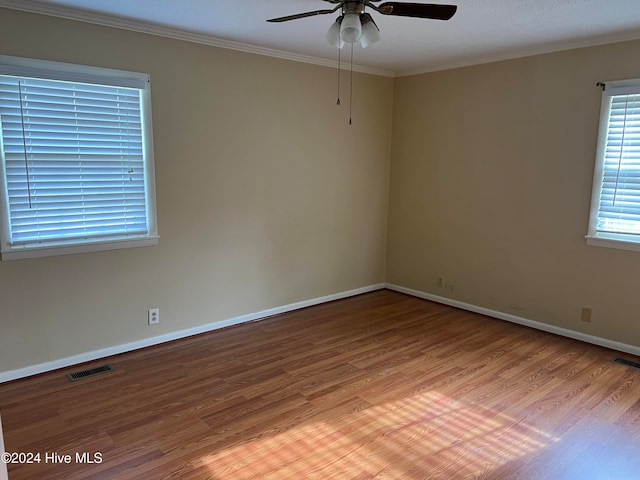 unfurnished room featuring light hardwood / wood-style floors, ceiling fan, and crown molding