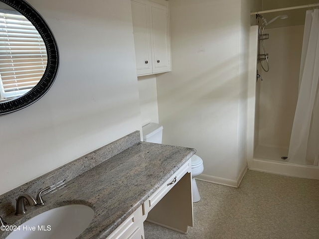 bathroom with vanity, toilet, and walk in shower