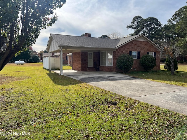 ranch-style home with a front lawn and a carport