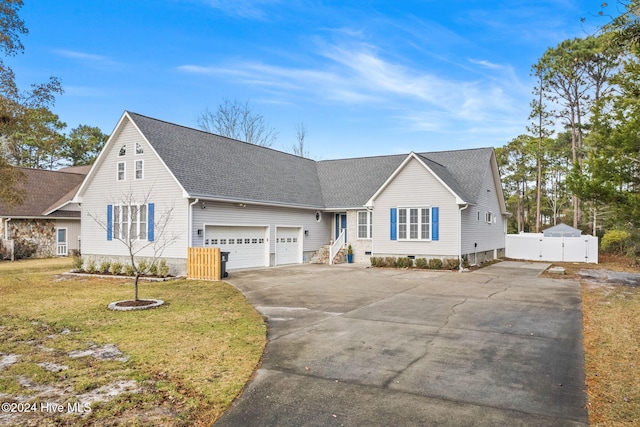 view of front of house with a front yard and a garage