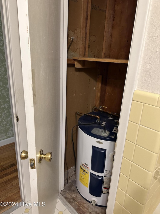 utility room featuring water heater