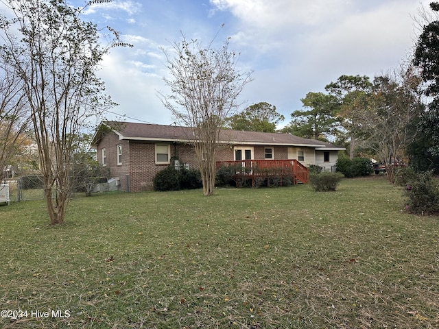 view of front facade featuring a front yard and a deck