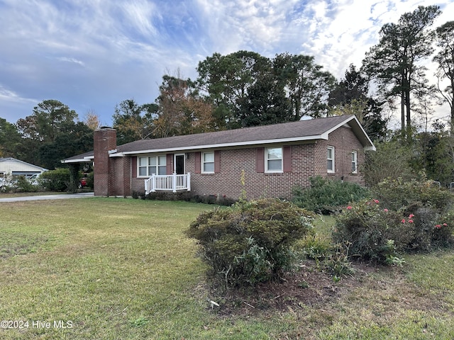 ranch-style house with a front yard, crawl space, brick siding, and a chimney