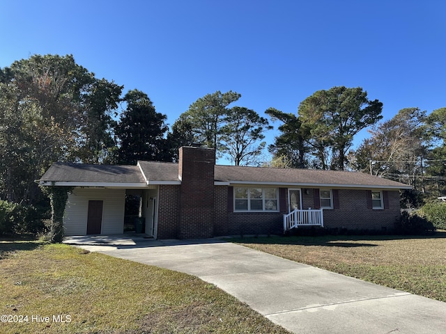 single story home with a front lawn and a carport