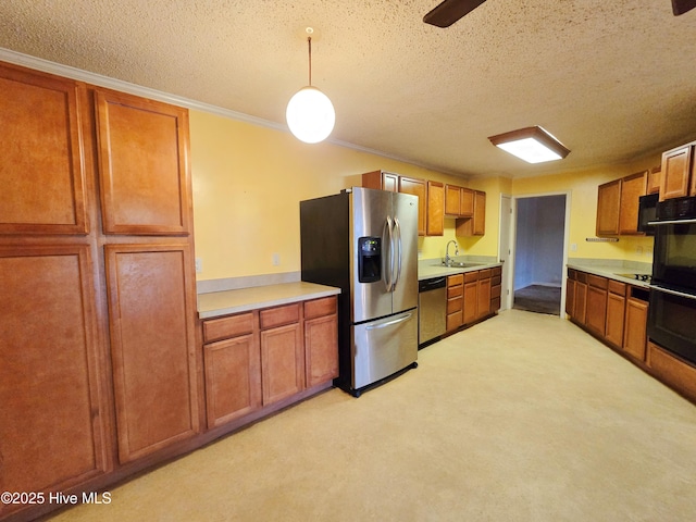 kitchen featuring brown cabinetry, light countertops, a sink, and black appliances