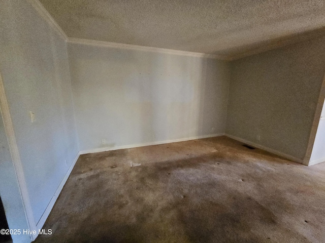 empty room with ornamental molding, carpet floors, a textured ceiling, and baseboards