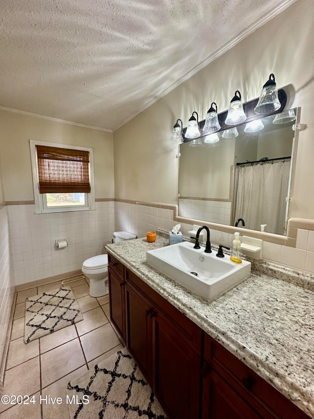 bathroom featuring tile patterned flooring, a textured ceiling, tile walls, and ornamental molding