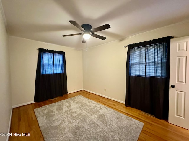 empty room featuring wood-type flooring and ceiling fan