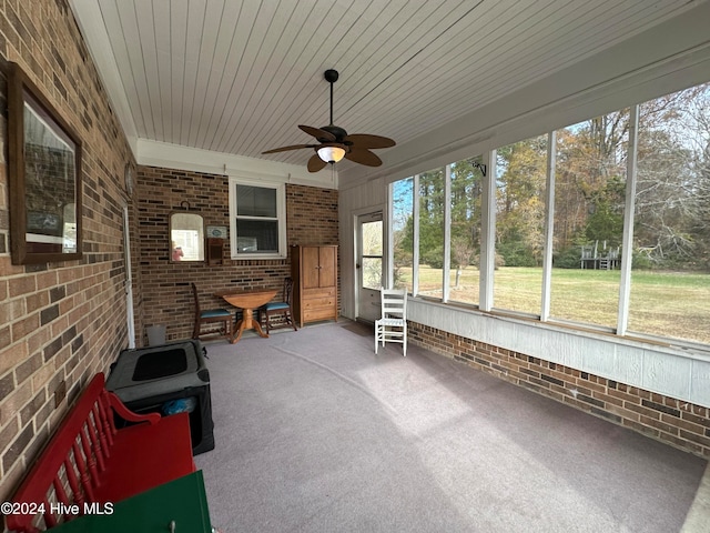 unfurnished sunroom featuring ceiling fan