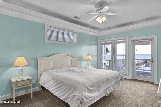 carpeted bedroom with a raised ceiling, access to outside, and ceiling fan