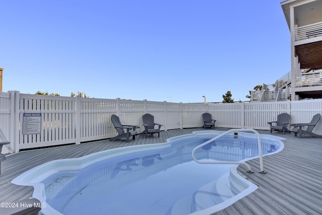 view of swimming pool with a wooden deck