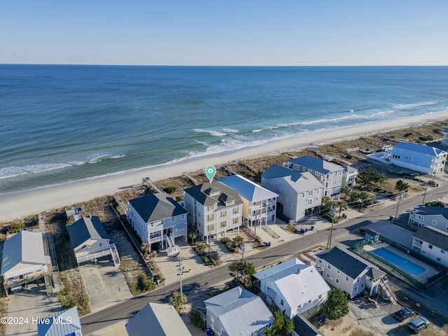 drone / aerial view with a water view and a beach view