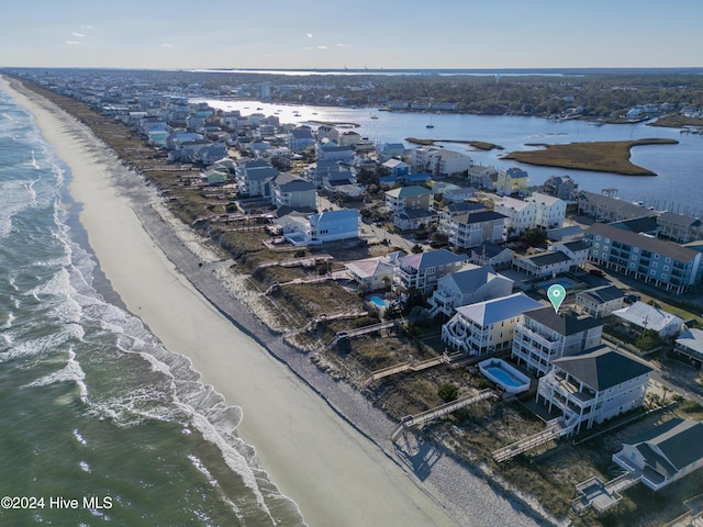 drone / aerial view with a water view and a view of the beach