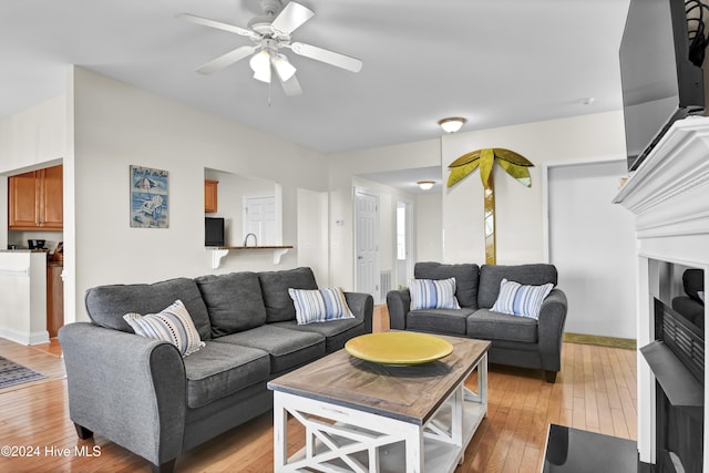 living room with ceiling fan and light wood-type flooring