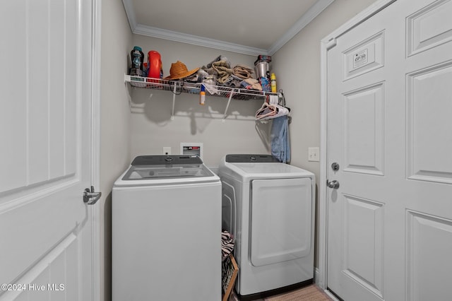 laundry room featuring washer and dryer and crown molding