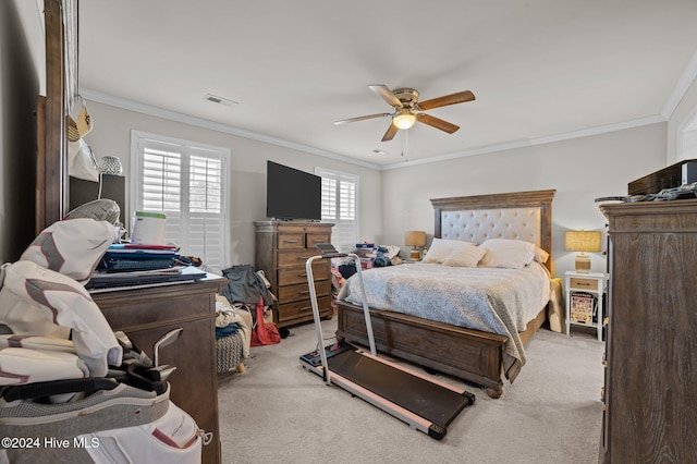 bedroom with light colored carpet, ceiling fan, and crown molding